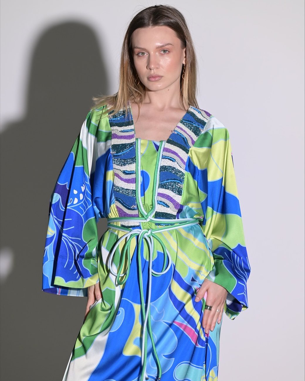 Blue and green dress with rope belt and chest accessories