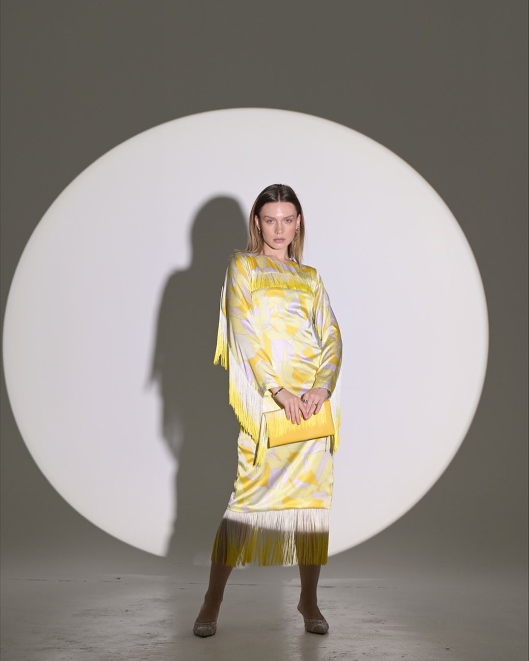 Yellow silky dress with small rope accessories on the sleeves and hem