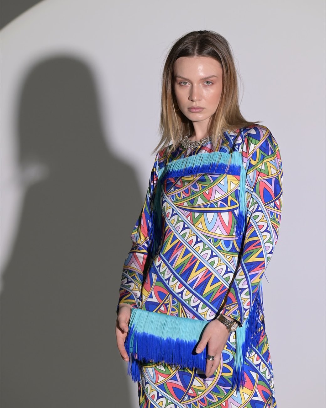 Blue silk dress with small rope accessories on the sleeves and hem
