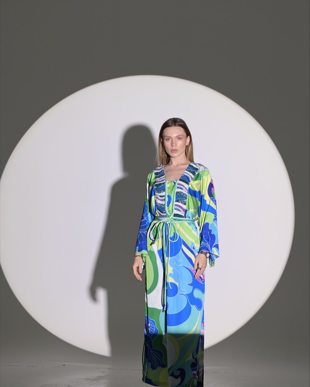 Blue and green dress with rope belt and chest accessories