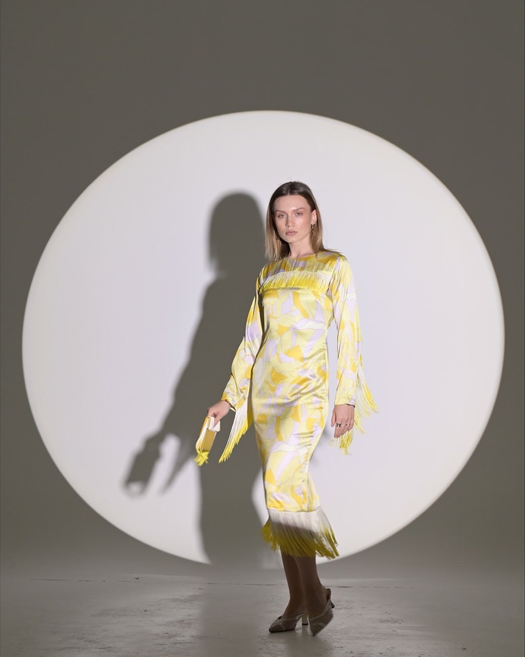 Yellow silky dress with small rope accessories on the sleeves and hem