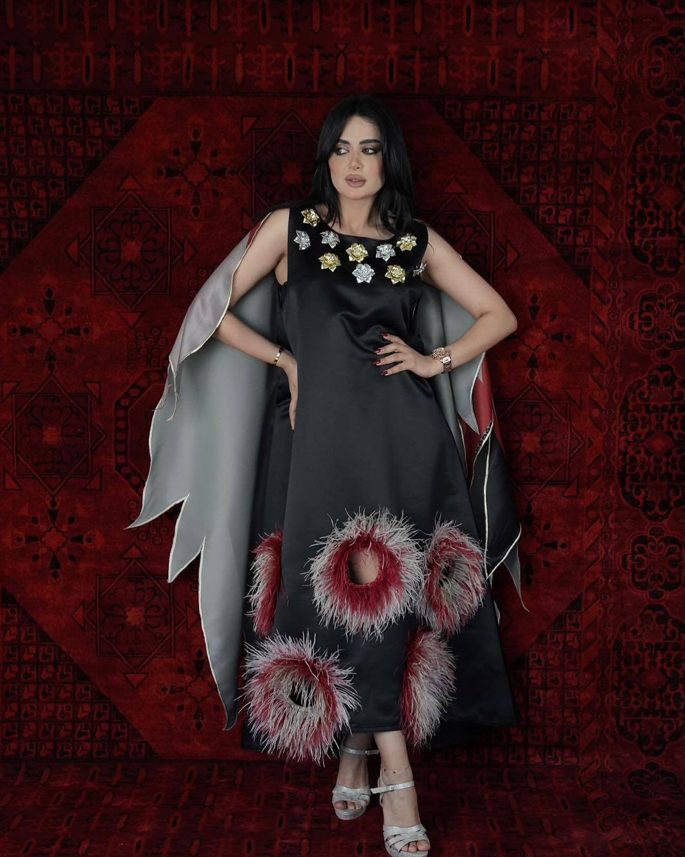 Black Dress with feather openings and butterfly back cape with roses on the chest