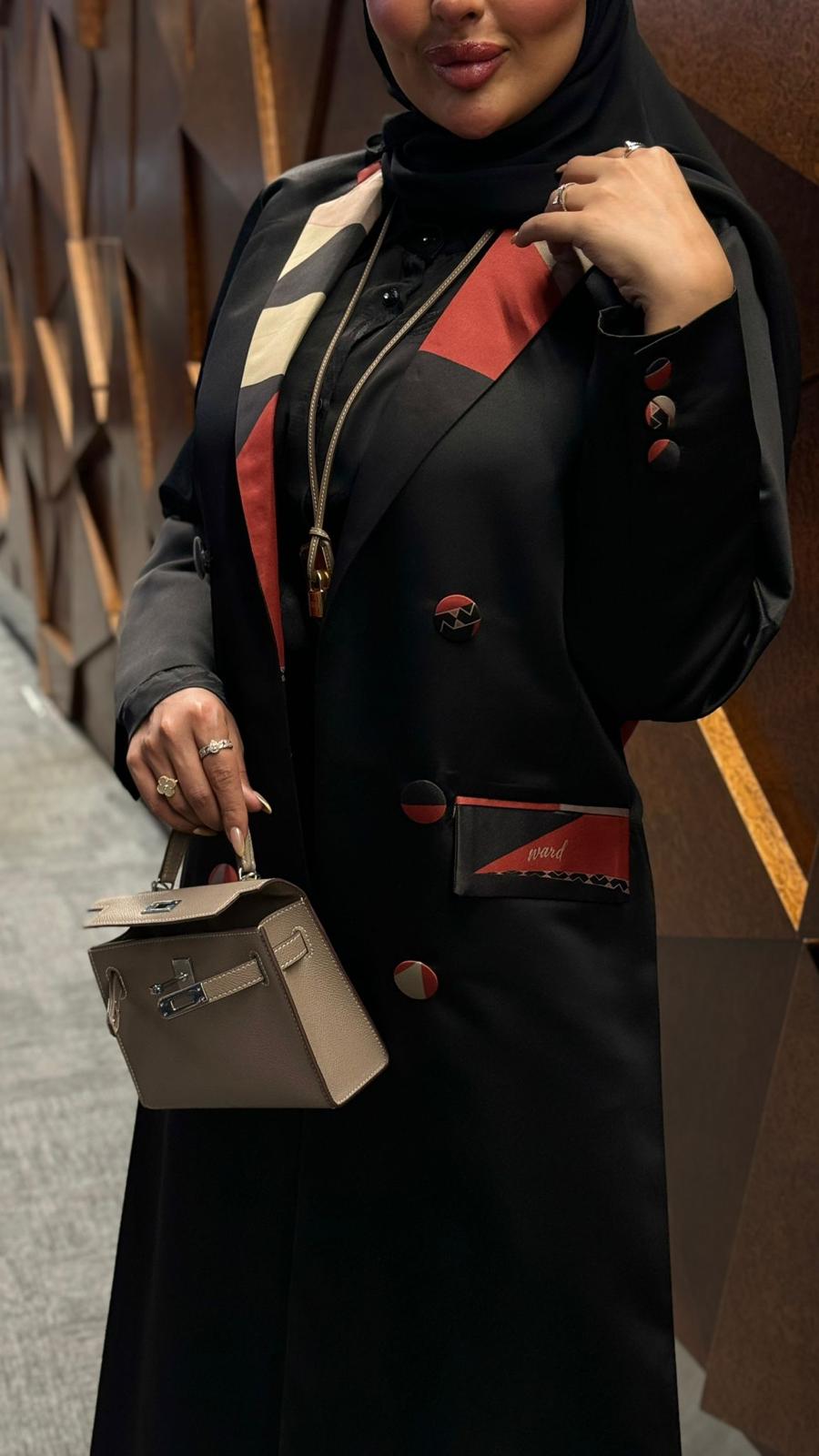 Black abaya with elegant red pieces of fabric