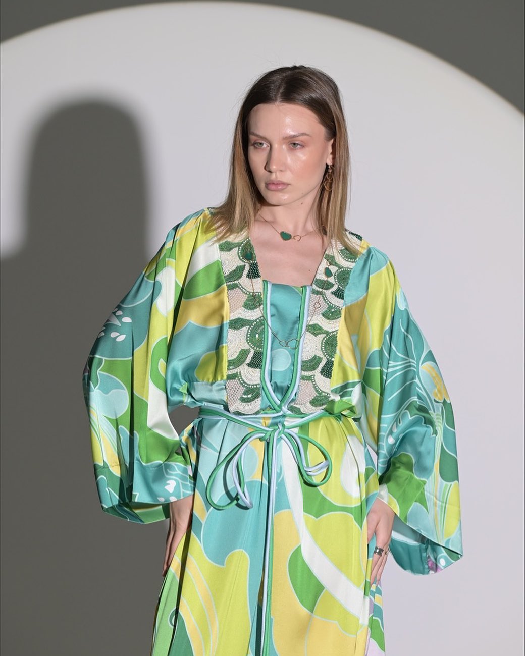Green and yellow dress with rope belt and chest accessories