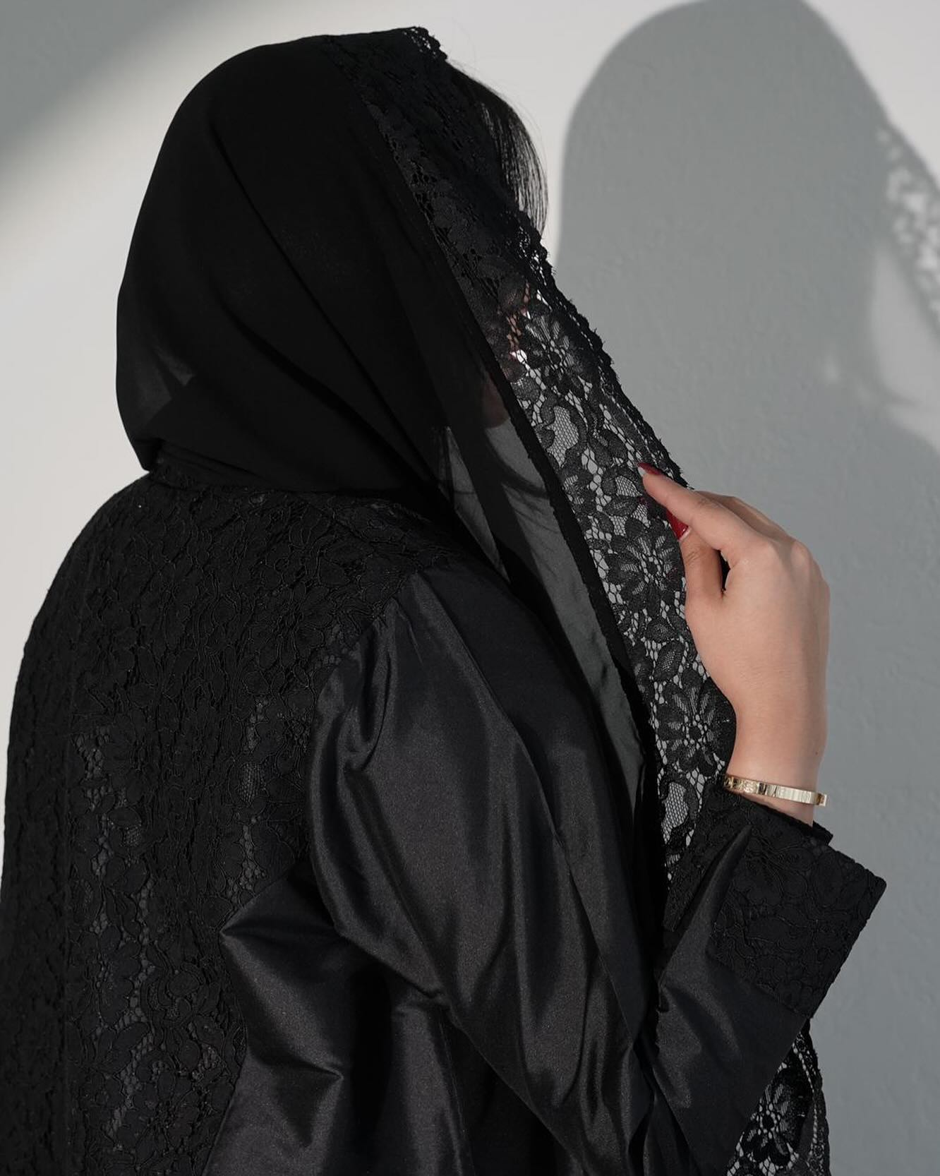 Black abaya with lace and gemstone accessories