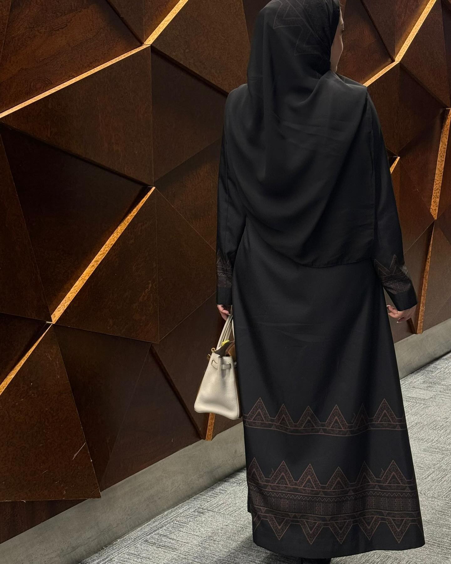 Elegant black abaya with pockets and decorations at the bottom