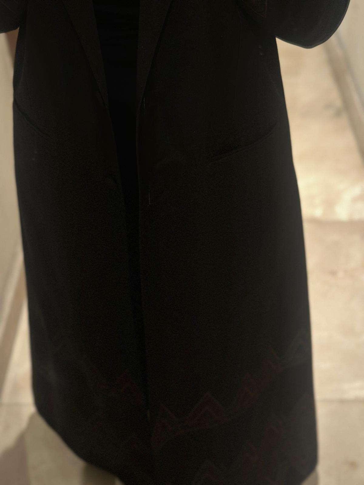 Elegant black abaya with pockets and decorations at the bottom